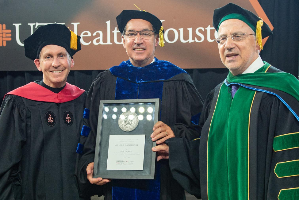 GSBS Dean Michael R. Blackburn, PhD, center, receives a dean emeritus award from MD Anderson President Peter WT Pisters, MD, left, and UTHealth Houston President Giuseppe N. Colasurdo, MD, right.